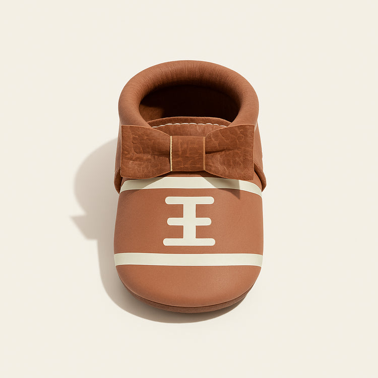 Touchdown II Bow Baby Shoe — primary — Clean ecommerce product shot — refreshed editorial photography
