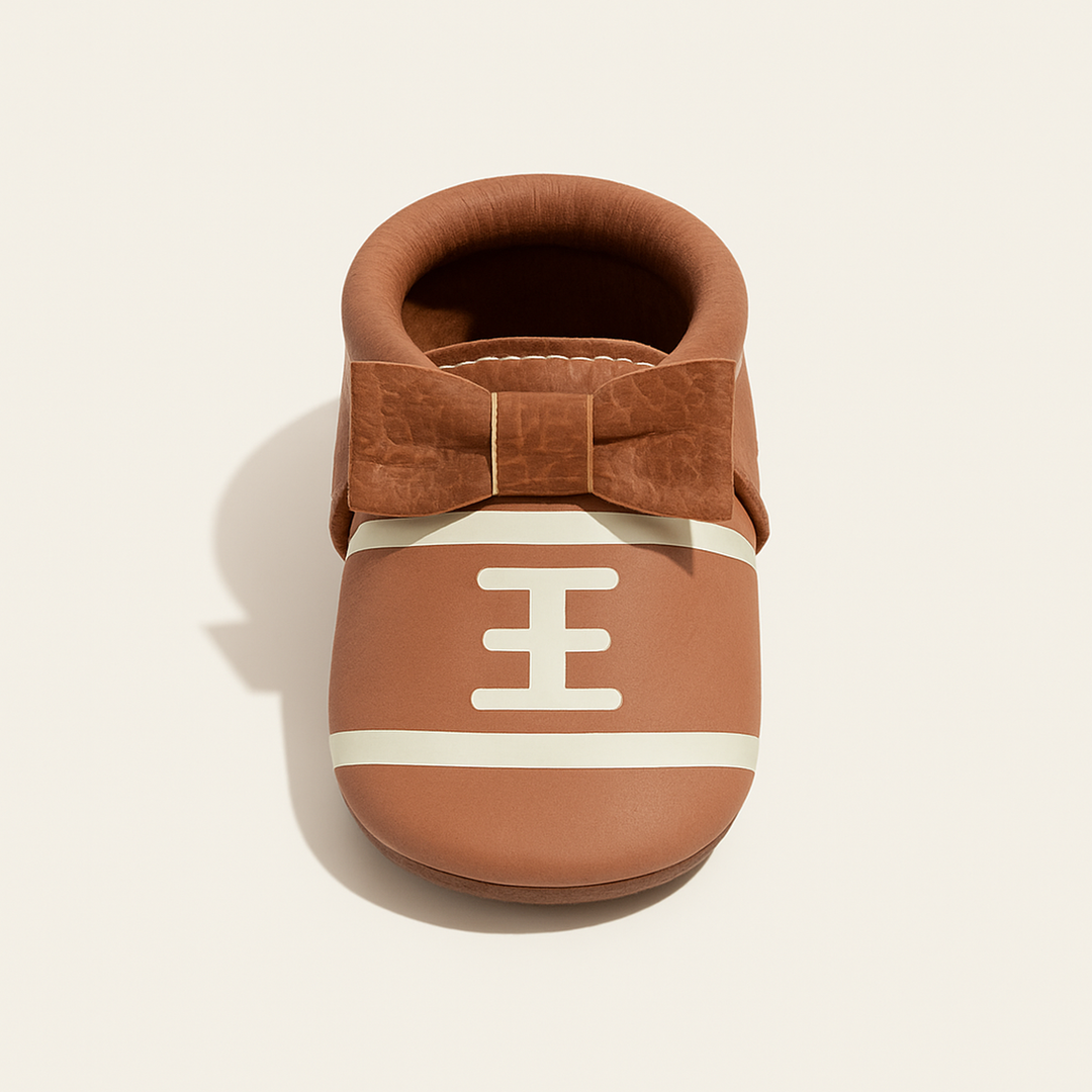 Touchdown II Bow Baby Shoe — primary — Clean ecommerce product shot — refreshed editorial photography